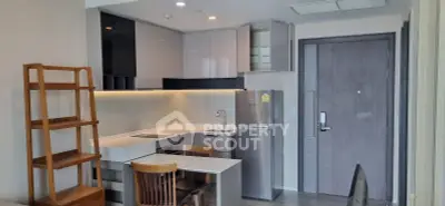 Modern kitchen with sleek cabinetry and stainless steel appliances in a stylish apartment.