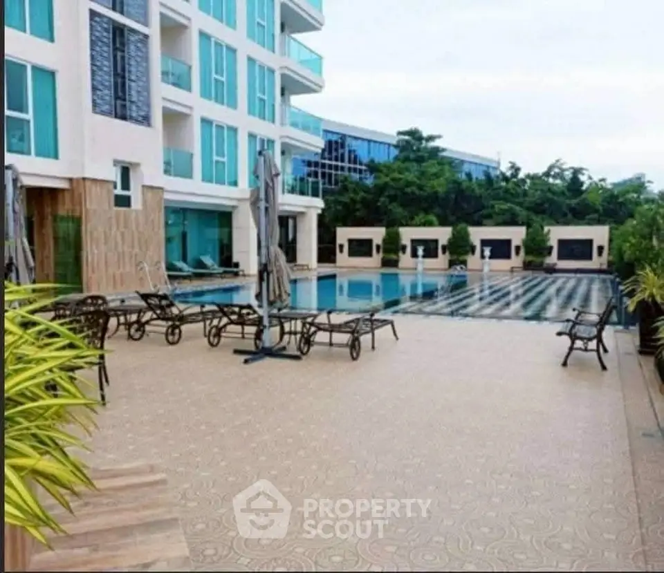 Luxurious apartment complex with a stunning outdoor pool area and modern design.