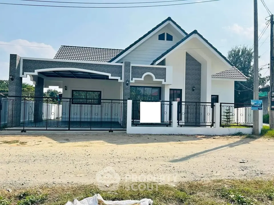 Charming modern house with unique architectural design and spacious front yard.