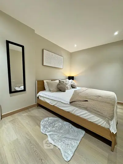 Modern bedroom with cozy decor and stylish wooden flooring