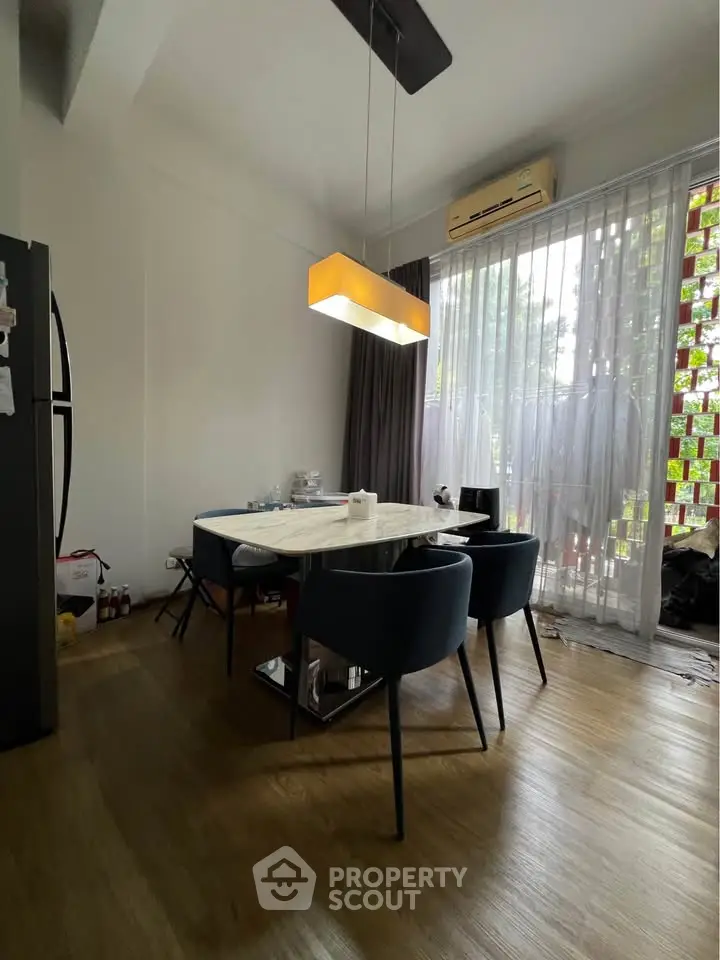 Modern dining area with stylish lighting and floor-to-ceiling windows