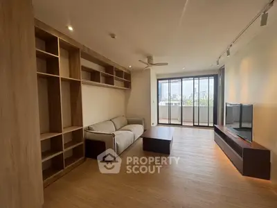 Spacious living room with modern furniture and city view balcony