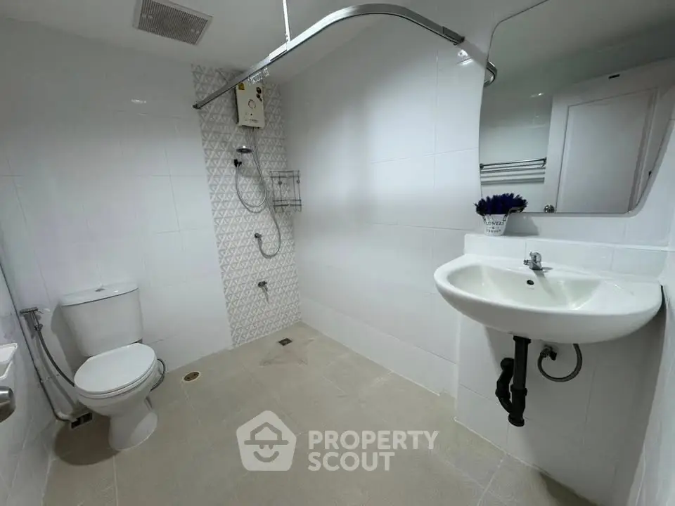 Modern bathroom with sleek white tiles and stylish fixtures, perfect for a contemporary home.