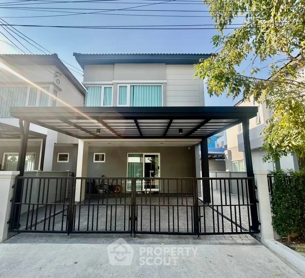 Modern two-story house with gated driveway and sleek design
