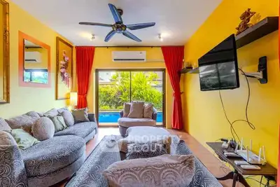 Vibrant living room with pool view, stylish decor, and modern amenities.