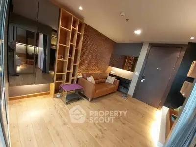 Modern living room with leather sofa and wooden flooring