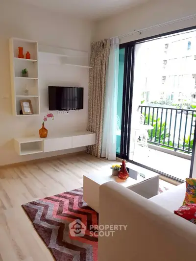 Modern living room with balcony view, stylish decor, and natural light