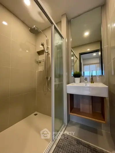 Modern bathroom with glass shower and sleek sink design
