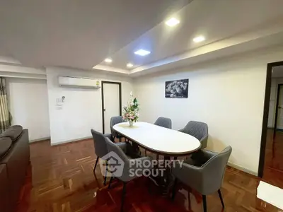 Elegant dining area with modern furniture and stylish lighting in a spacious living room.