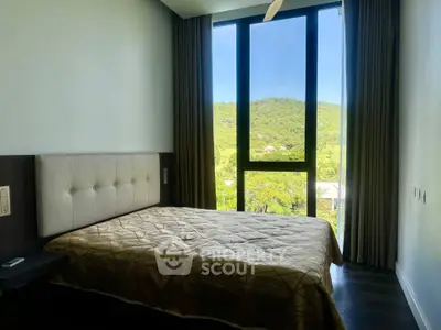 Modern bedroom with large window offering scenic green view