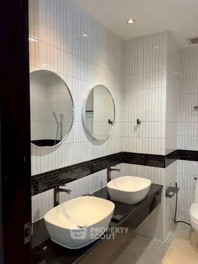 Modern bathroom with dual sinks and stylish round mirrors