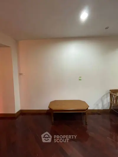 Spacious living area with wooden flooring and elegant furniture