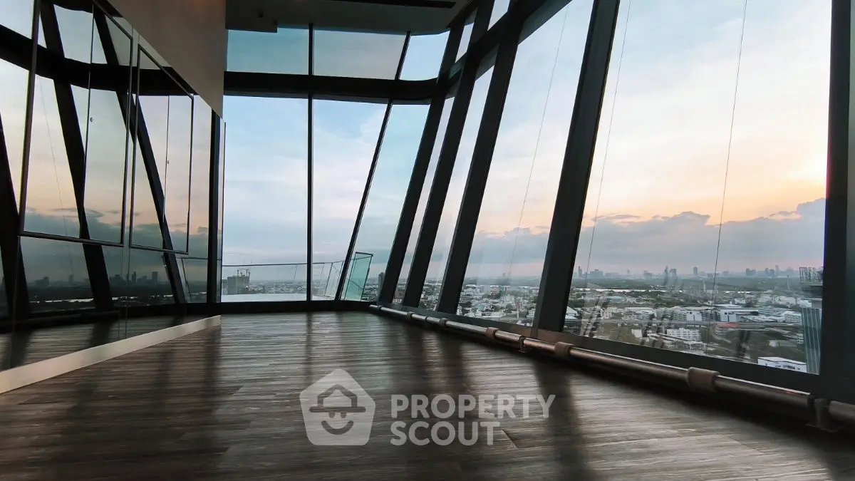 Stunning panoramic view from modern high-rise building with floor-to-ceiling windows and sleek design.