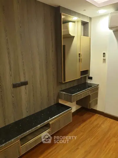 Modern bedroom with stylish wood paneling and built-in storage solutions