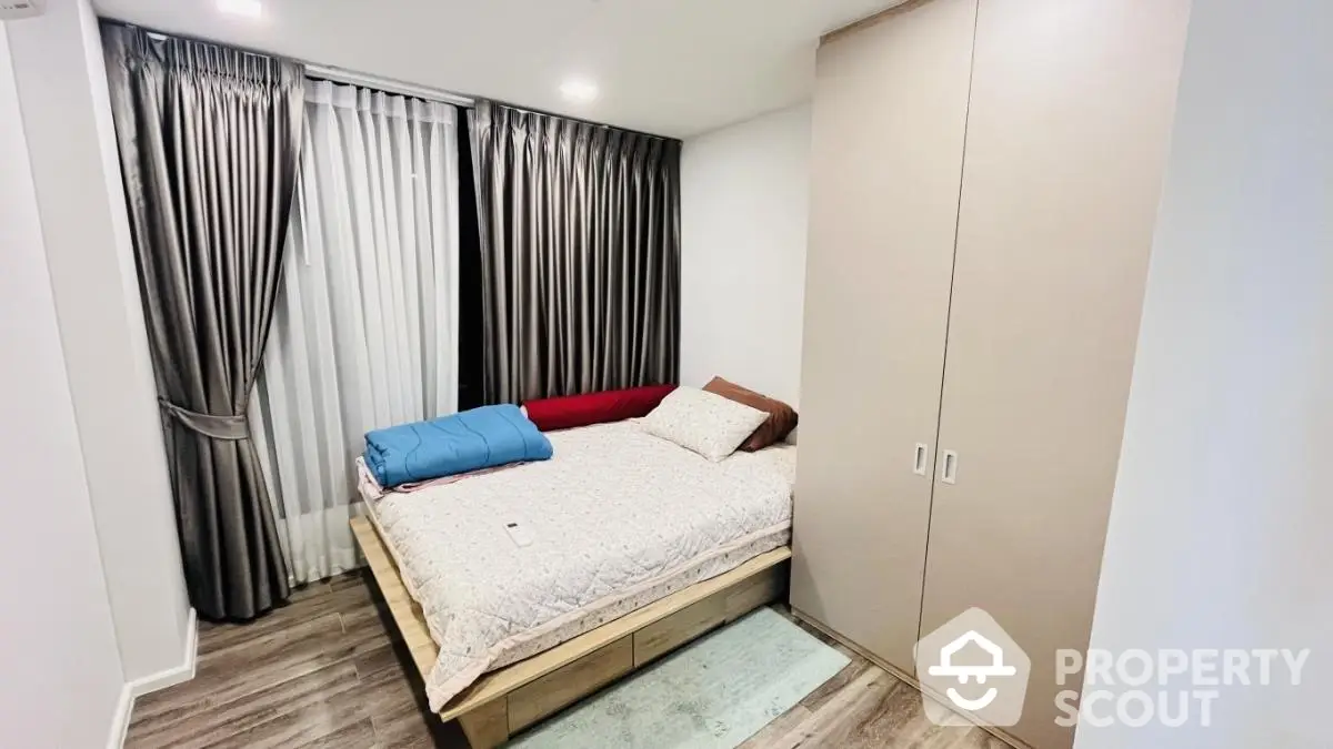 Cozy bedroom with modern design, featuring a comfortable bed and ample storage space.