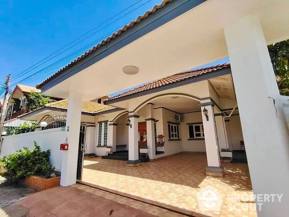 Charming single-story home with spacious carport and tiled patio in sunny neighborhood.