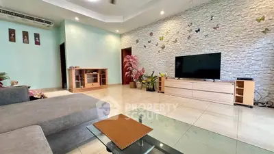 Spacious living room with modern decor and wall-mounted TV