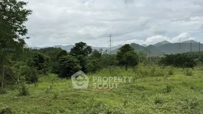 Scenic land plot with lush greenery and mountain views, ideal for development or investment.