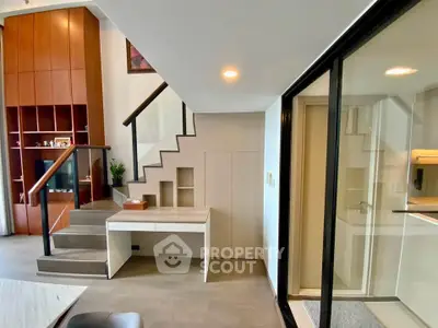 Modern duplex interior with stylish staircase and built-in storage solutions