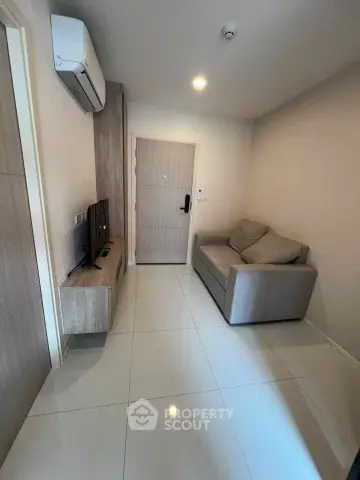 Modern living room with sleek furniture and air conditioning, perfect for cozy urban living.
