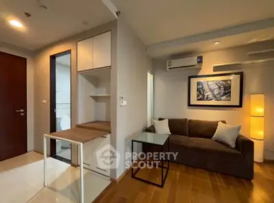 Modern living room with cozy sofa, stylish decor, and efficient layout in urban apartment.