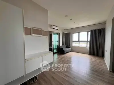 Spacious modern living room with large windows and wooden flooring