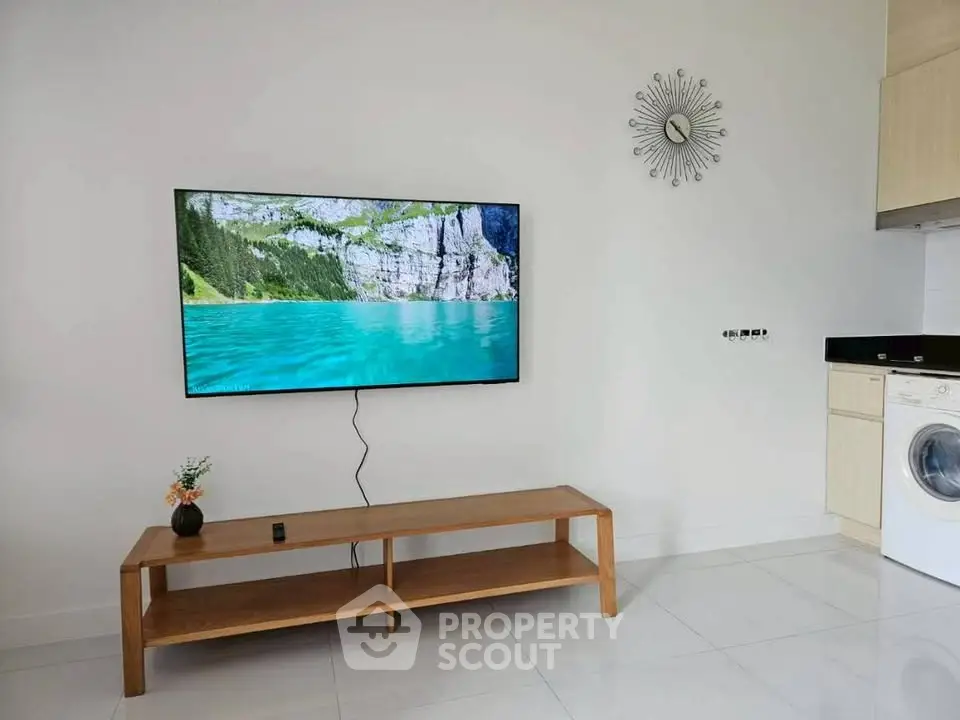 Modern living room with wall-mounted TV and sleek furniture