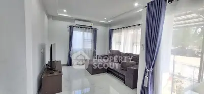 Spacious living room with modern decor and large windows for natural light.