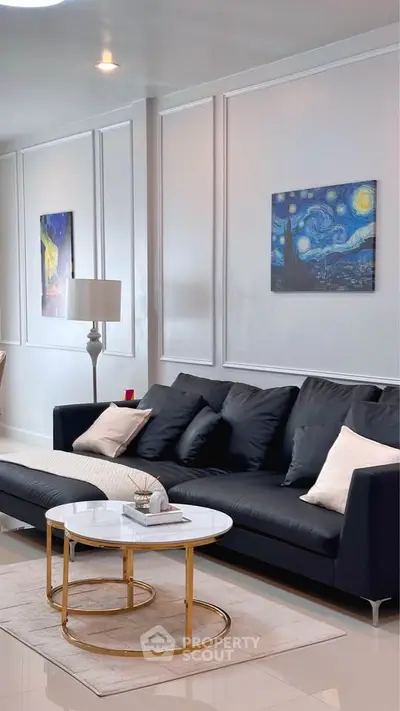 Modern living room with elegant black sofa and stylish decor