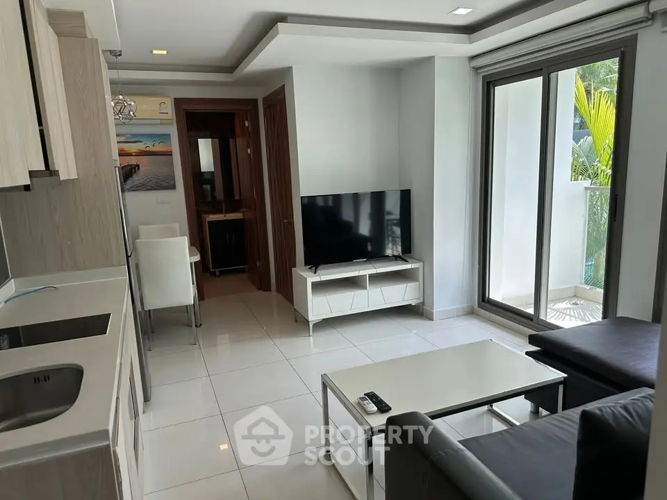 Modern living room with sleek furniture and balcony access, perfect for urban living.