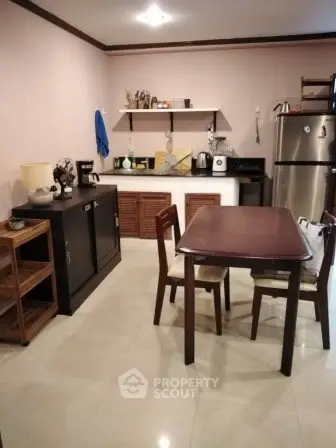 Cozy kitchen with dining area and modern appliances in a stylish home.