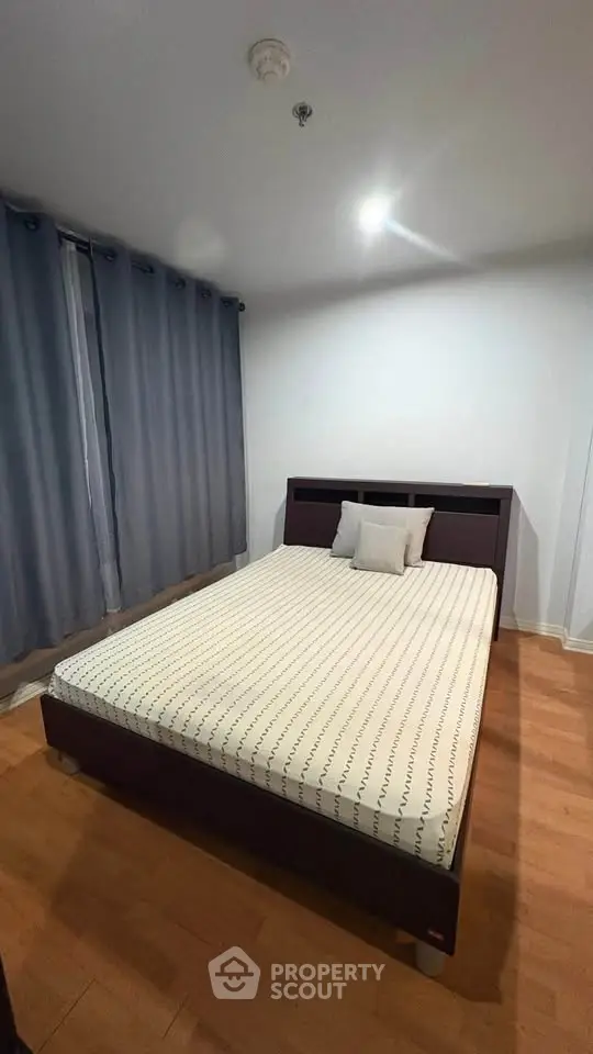 Cozy bedroom with modern bed and wooden flooring, perfect for restful nights.