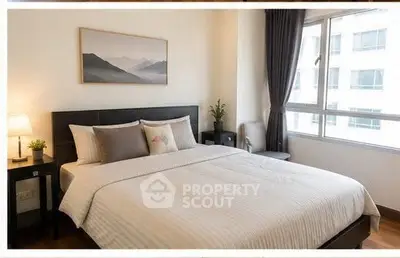 Spacious bedroom with large window and modern decor in urban apartment.