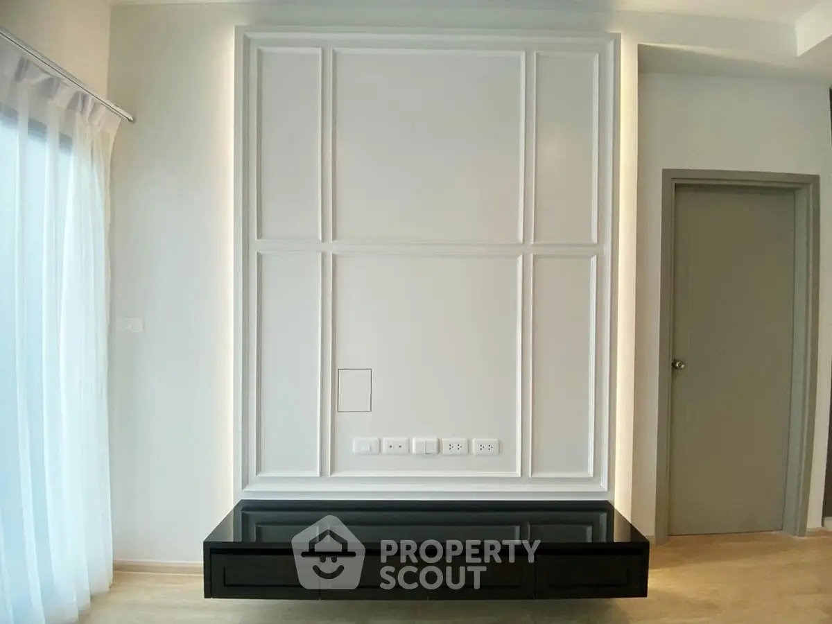 Modern living room with sleek built-in entertainment unit and elegant paneling