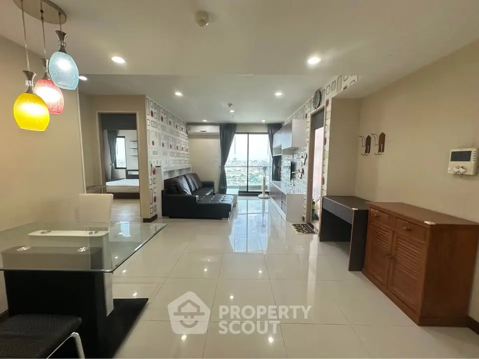 Spacious modern living room with stylish lighting and city view, perfect for urban living.