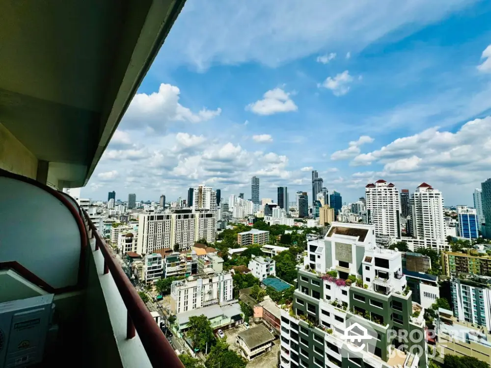 Stunning cityscape view from high-rise balcony with clear blue sky