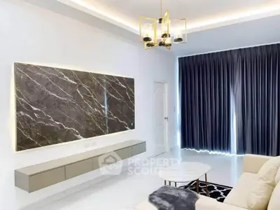 Modern living room with elegant lighting and sleek marble wall feature.