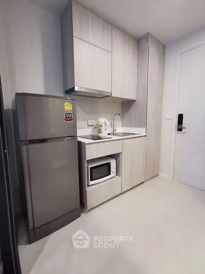 Modern compact kitchen with sleek cabinetry and stainless steel appliances