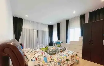 Spacious bedroom with modern decor and ample natural light