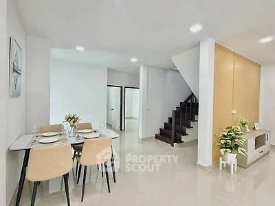 Modern dining area with elegant staircase and stylish decor