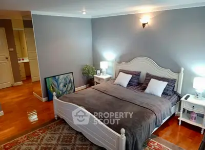 Spacious bedroom with elegant decor and cozy lighting