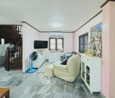 Charming living room with cozy seating and modern decor, perfect for relaxation and entertainment.