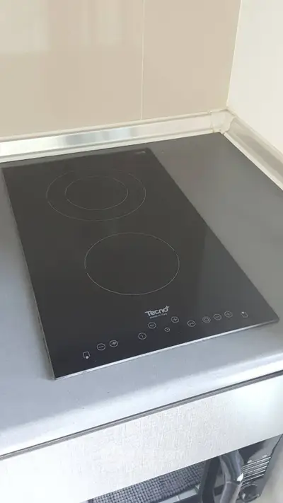 Modern kitchen with sleek electric cooktop and minimalist design