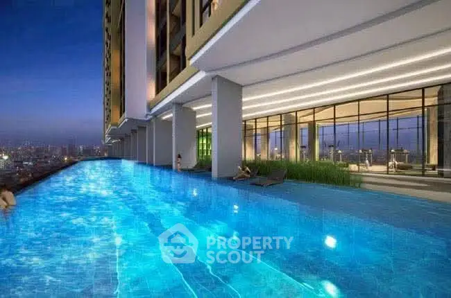 Luxurious high-rise building with stunning infinity pool and city view at dusk.