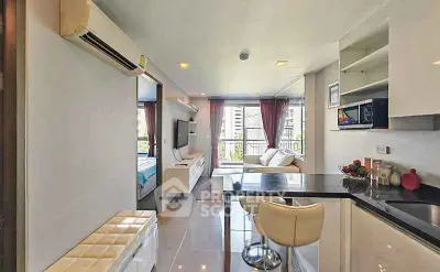 Modern open-plan living room with sleek kitchen and city view, perfect for urban living.
