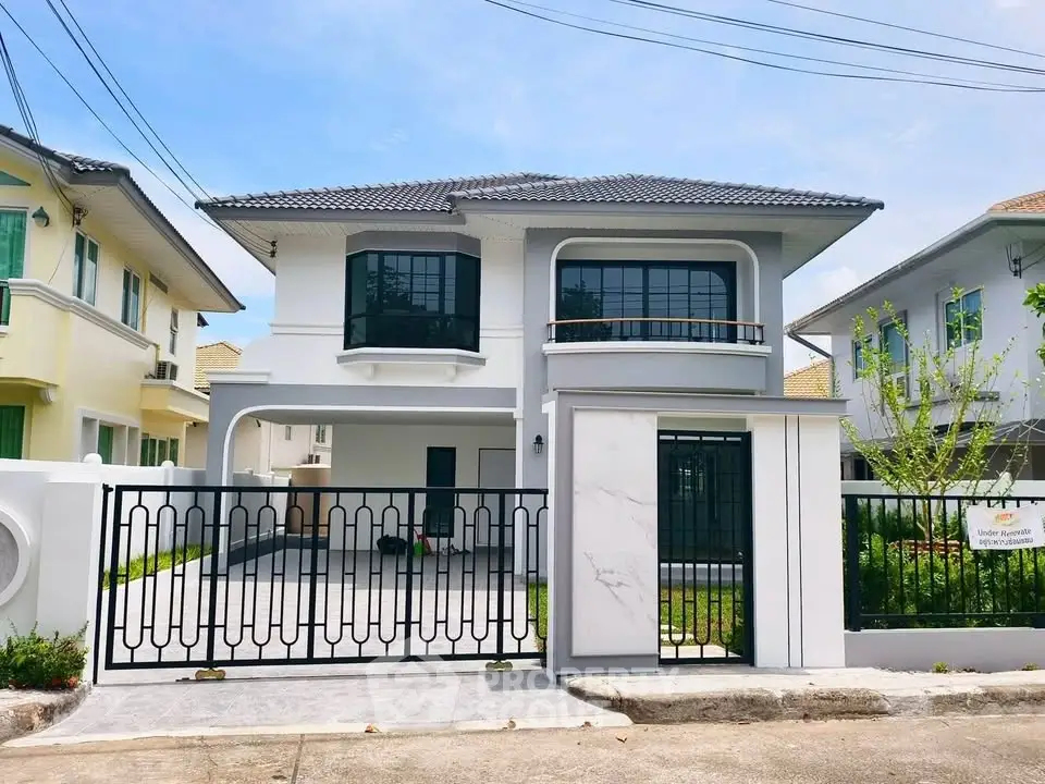 Stunning modern two-story house with sleek design and spacious driveway in a serene neighborhood.