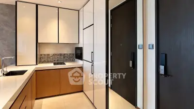 Modern kitchen with sleek cabinetry and built-in appliances in a stylish apartment.