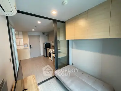 Modern compact apartment with sliding glass door and built-in storage