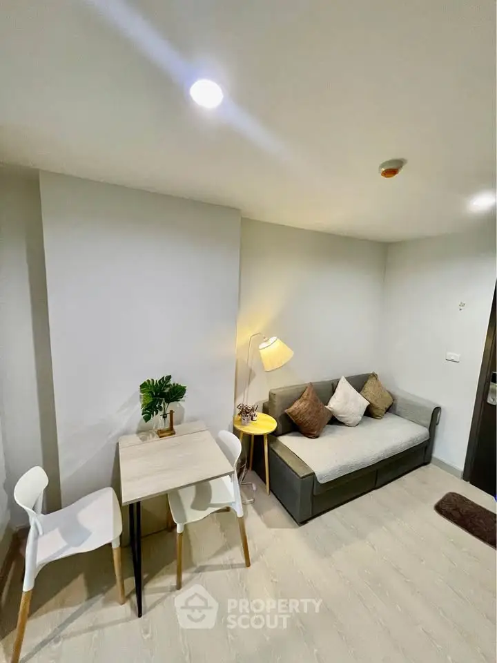 Cozy living room with modern decor and compact dining area, perfect for urban living.