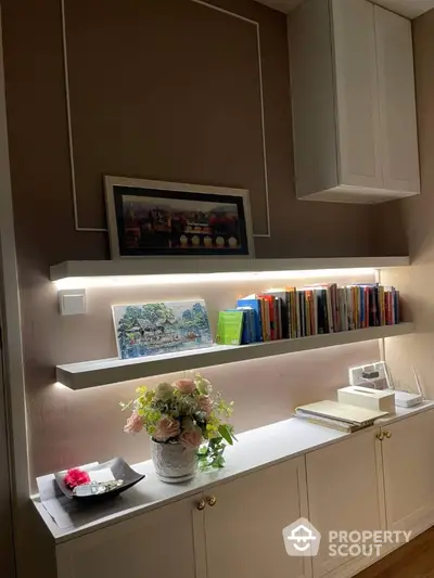 Elegant study area with illuminated shelves and decorative elements